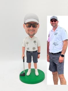 a man standing next to a golf bobble head