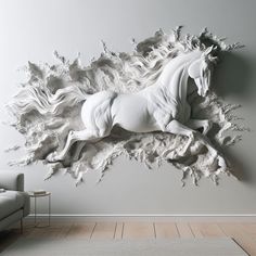 a white horse is running through the air in front of a gray wall and floor