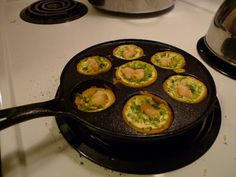 some food is being cooked in a pan on top of the stove and ready to go into the oven