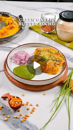 a table topped with plates filled with food and veggies on top of it