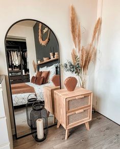 a bedroom with a mirror, dresser and bed in it's centerpieces