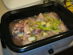 a black container filled with food on top of a counter next to a white stove