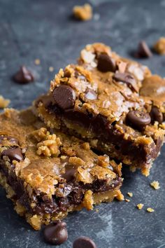 two pieces of chocolate chip cookie bars on a table