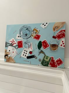 a painting with playing cards and glasses on top of a shelf next to a wall