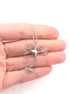 Sterling Silver Neuron Necklace STEM Gift Tree of Life Psychology Gift Science Gift Science Jewelry Graduation Gift Biology Gift Nerve STEM Cells of the nervous system, called nerve cells or neurons, are specialized to carry "messages" through an electrochemical process. A brilliant neuron stem hangs from a silver necklace and is 17" in length. Each necklace is designed with a smooth brilliant finish that will catch the light. Comes on a beautiful display card ready for gift giving. Add a woven Psychology Jewelry, Stem Jewelry, Biology Student Gifts, Biology Ring, Science Inspired Jewelry, Science Jewelry Biology, Biology Jewelry, Nerve Cells, Psychology Gifts