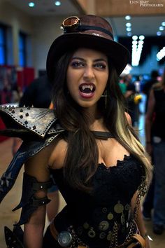 a woman dressed in steampunk clothing and holding a hat with her mouth open