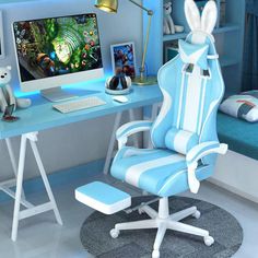 a blue and white computer chair sitting in front of a desk with a monitor on it