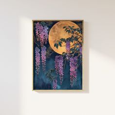 a painting hanging on the wall with purple flowers in front of it and a full moon