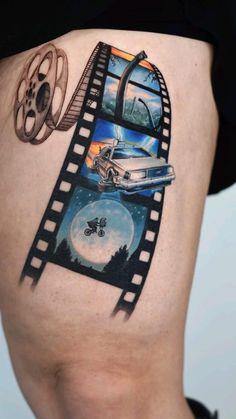 a woman's thigh with an image of a car and film strip on it