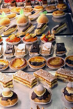 a display case filled with lots of different types of desserts