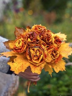 a person holding a bouquet of yellow flowers