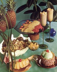 pineapples, bananas, and other tropical foods are arranged on serving platters