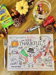 a thanksgiving coloring page with markers, pencils and crayons on the table