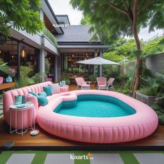 an inflatable swimming pool on the deck of a house with chairs and tables around it