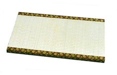 a close up of a mat on a white surface with brown and gold designs around it