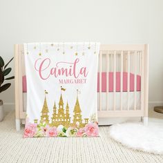 a white crib with pink and gold decor