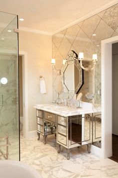 a bathroom vanity with two sinks and mirrors