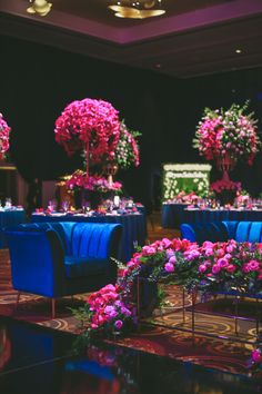 the tables are decorated with pink flowers and blue linens for an elegant dinner party