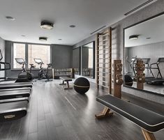 an empty gym with treadmills and exercise equipment