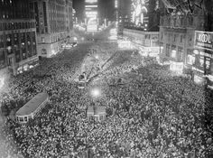 an aerial view of a crowded city street at night in the early 1900's