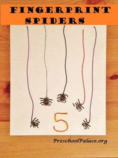 the number five is made out of paper with spider's on it