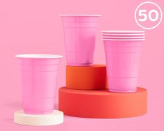 pink cups are stacked on top of each other with the number 50 in the background