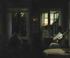 a person sitting in a room with a guitar by a window and another person playing the guitar