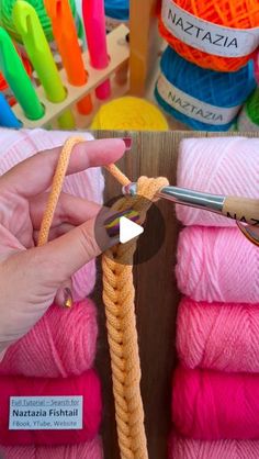 a person is knitting yarn with crochet hooks