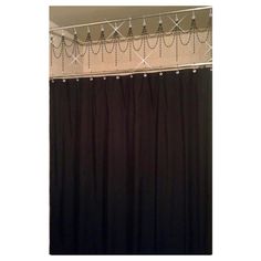 a black shower curtain with some lights on the top and bottom bars hanging from it's side