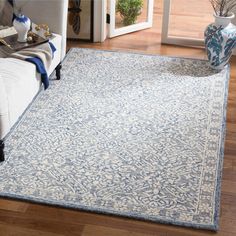 a blue and white rug in a living room