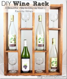 three wine bottles and two glasses in a wooden box with text overlay saying diy wine rack a beautiful way to display your favorite wines