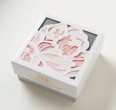 a white box with pink cut outs on it