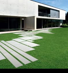 a modern house with grass in the front yard