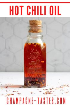 a bottle filled with hot chili oil sitting on top of a table