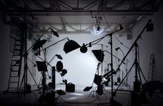 an empty photo studio with lights and lighting equipment in front of the photographer's head