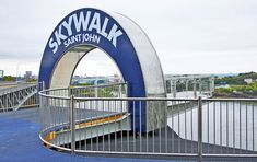 the skywalk sign is located on top of a metal structure with blue and white paint