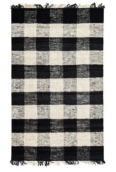 a black and white checkered rug with fringes