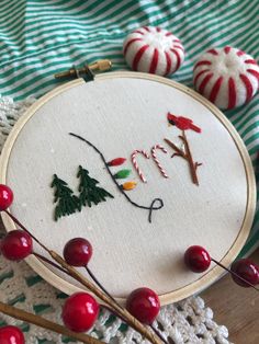 a close up of a embroidery on a table with christmas decorations and candy canes