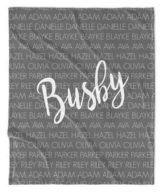 a black and white blanket with the word bushy written in large letters on it