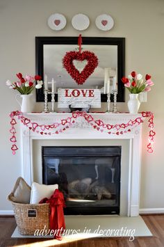 a fireplace decorated for valentine's day with flowers and candles