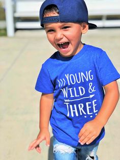 a young boy wearing a blue shirt and hat