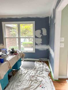 the room is being painted with blue and white paint