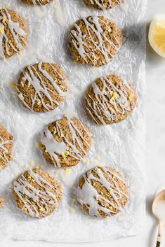 lemon cookies drizzled with white icing on a sheet of wax paper