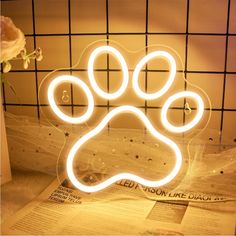 a neon sign with a dog's paw on it