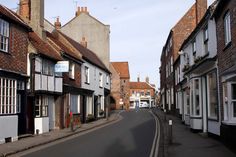 an empty street lined with old buildings