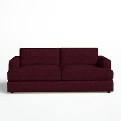 a red couch sitting on top of a white floor