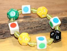 a close up of a bracelet made out of dices on a wooden table top