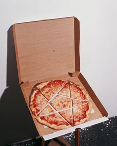 a pizza in a cardboard box on a table