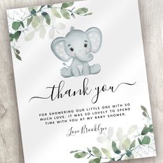 a thank card with an elephant on it and greenery around the edges that reads, thank you for showering our little one with so much love