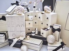 many boxes are stacked on top of each other with black and white decorations around them